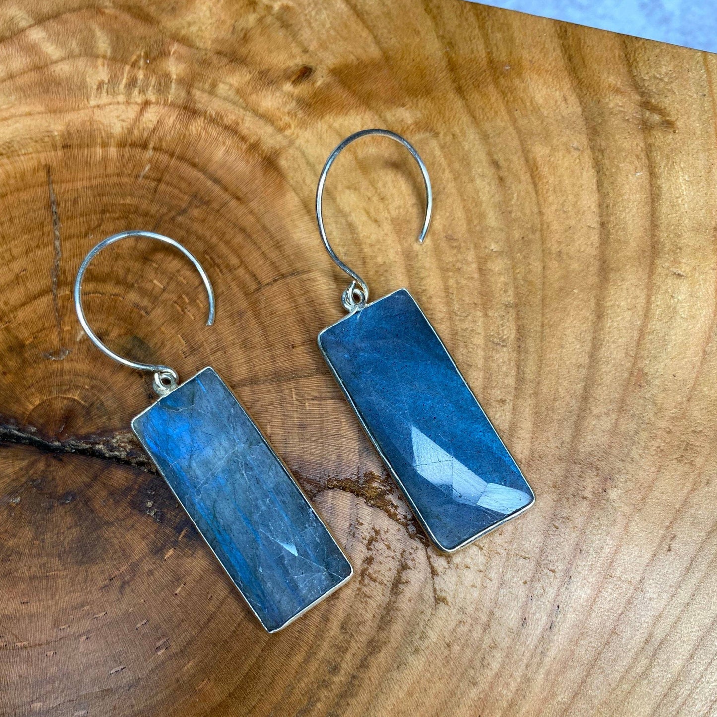 rectangle labrodorite earrings with sterling silver on piece of reclaimed wood with knot